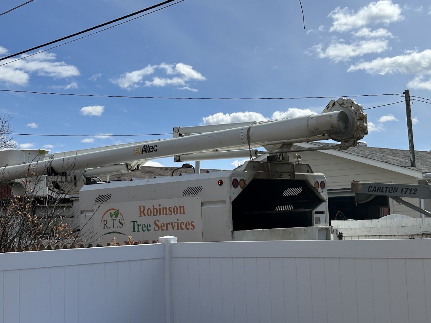 Robinson Tree Services branded bucket truck on site